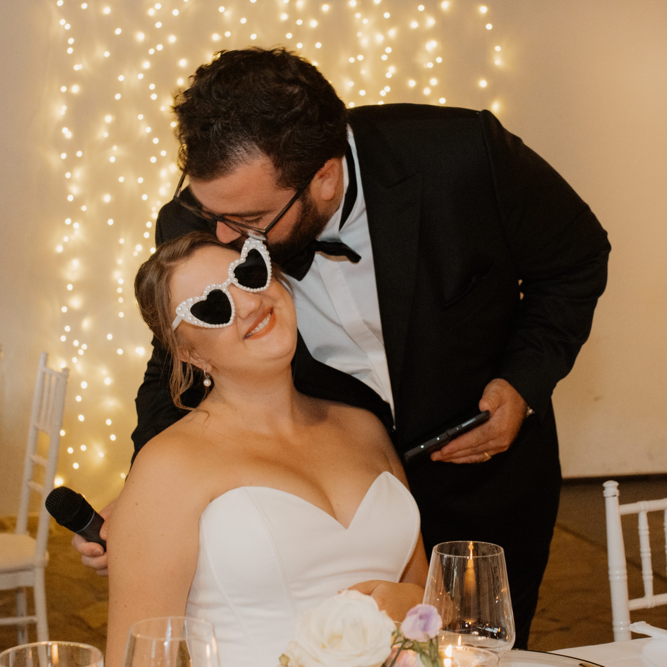 groom kisses bride on forhead