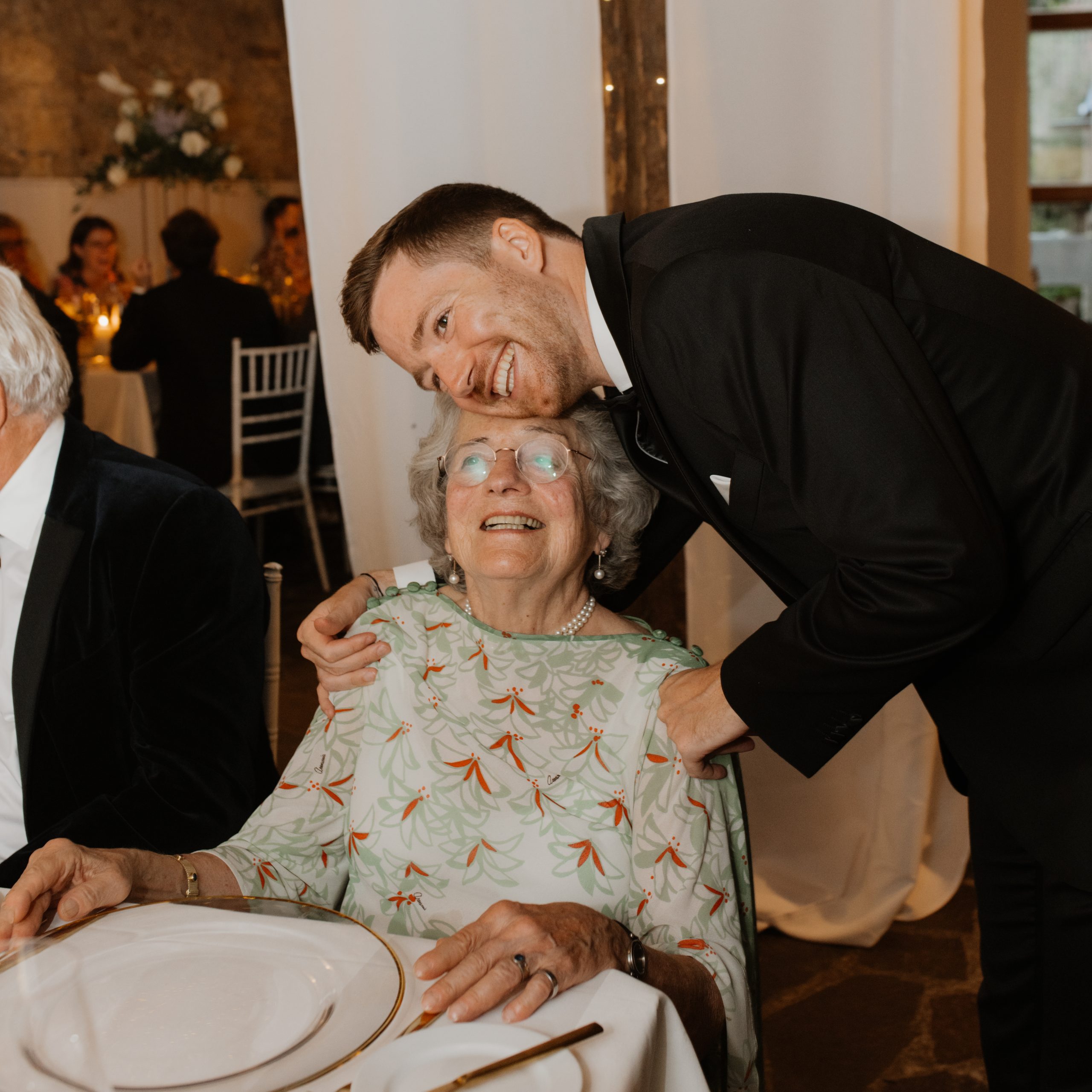 wedding guest with grandma smiling and cuddling