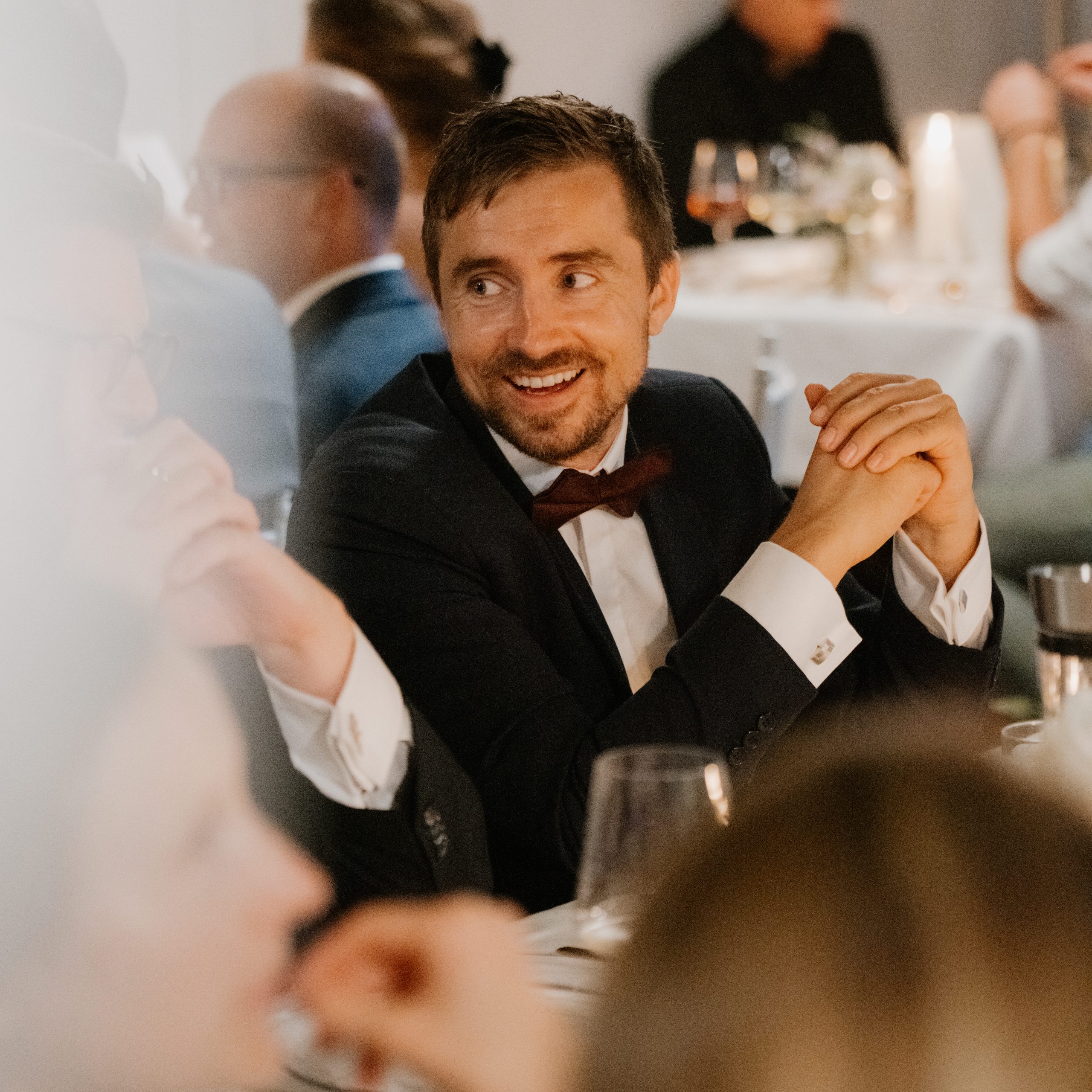 wedding guest is smiling to bride during dinner